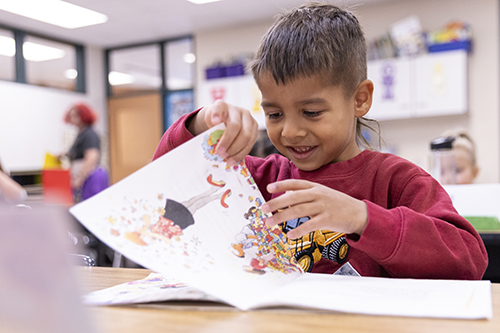 a student pages through a book